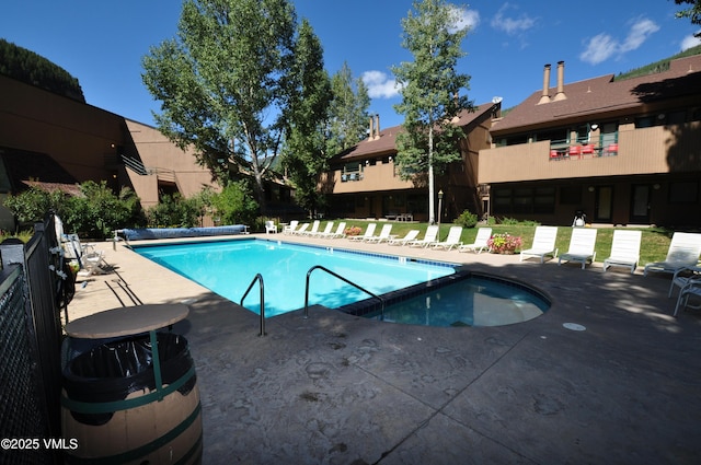 pool featuring a patio and fence