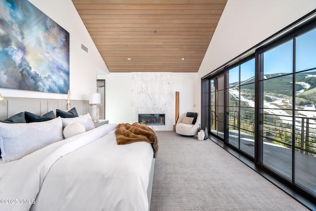 1326 Spraddle Creek Rd, Vail, CO 81657 - carpeted bedroom featuring wooden ceiling, access to outside, high vaulted ceiling, and a fireplace