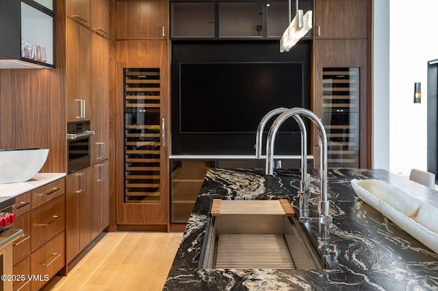 1326 Spraddle Creek Rd, Vail, CO 81657 - kitchen with wine cooler, light wood-style floors, and modern cabinets