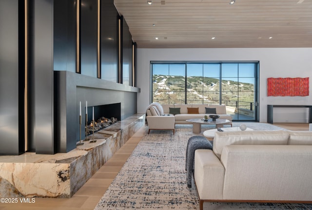1326 Spraddle Creek Rd, Vail, CO 81657 - living room featuring wood ceiling, healthy amount of natural light, light wood finished floors, and a fireplace