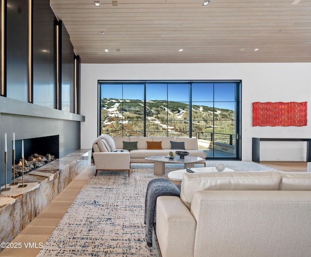 1326 Spraddle Creek Rd, Vail, CO 81657 - living room with wooden ceiling, healthy amount of natural light, a tiled fireplace, wood finished floors, and recessed lighting