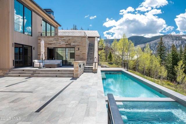 1326 Spraddle Creek Rd, Vail, CO 81657 - view of swimming pool with a patio, a mountain view, and a pool with connected hot tub