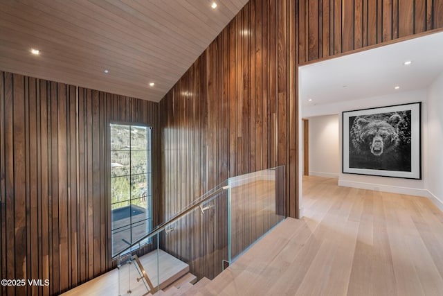 1326 Spraddle Creek Rd, Vail, CO 81657 - hallway with wooden walls, light wood-type flooring, recessed lighting, lofted ceiling, and an upstairs landing