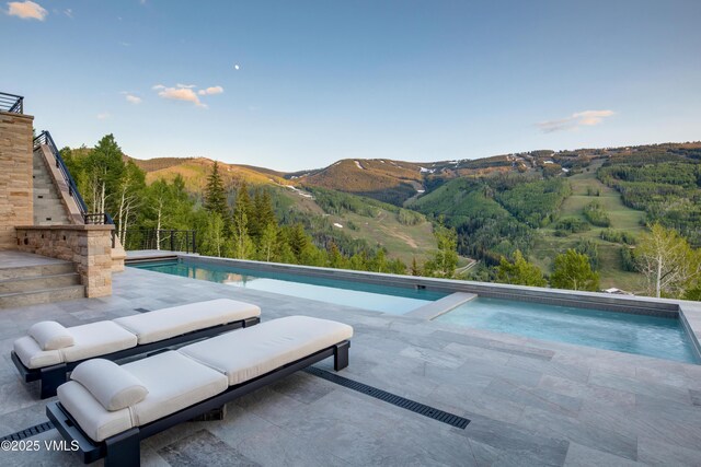 1326 Spraddle Creek Rd, Vail, CO 81657 - outdoor pool with a mountain view and a patio