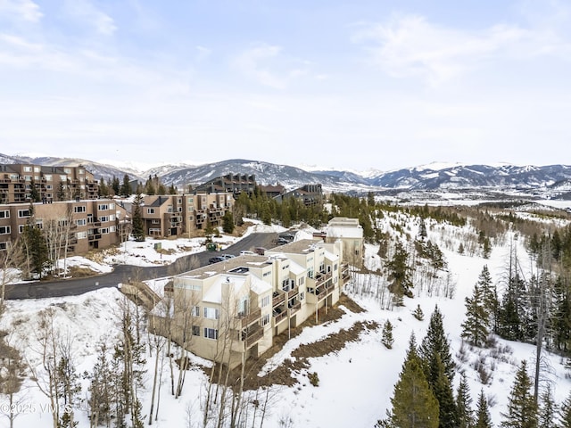 snowy aerial view featuring a mountain view