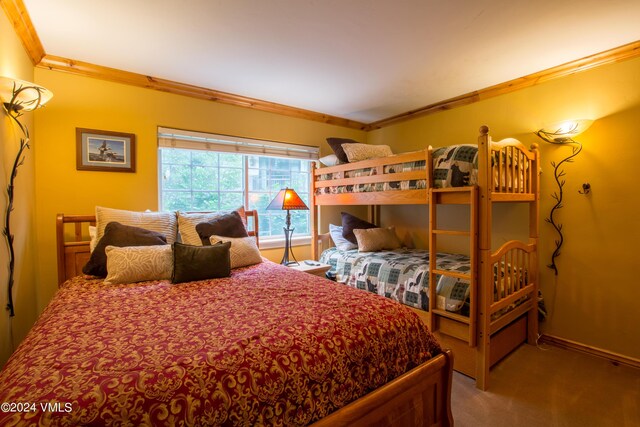 carpeted bedroom with ornamental molding