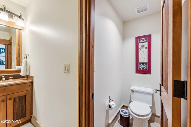 102 Village Walk, Beaver Creek, CO 81620 - half bathroom with toilet, vanity, baseboards, and visible vents