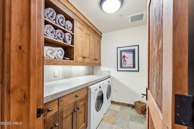 102 Village Walk, Beaver Creek, CO 81620 - washroom with stone finish flooring, visible vents, washer and dryer, baseboards, and cabinet space