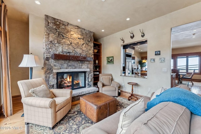 102 Village Walk, Beaver Creek, CO 81620 - living room featuring recessed lighting, a stone fireplace, baseboards, and wood finished floors