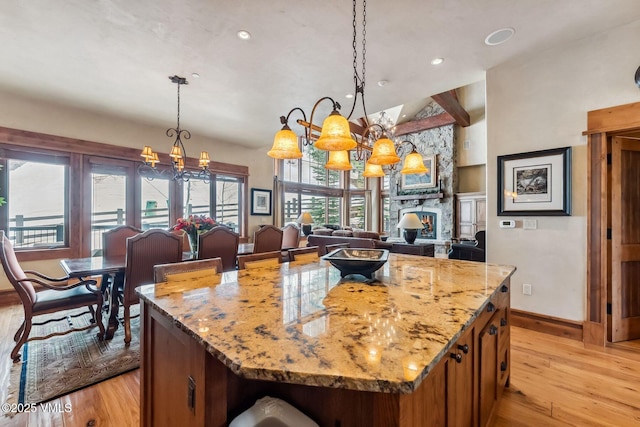 102 Village Walk, Beaver Creek, CO 81620 - kitchen featuring baseboards, light wood-type flooring, an inviting chandelier, and lofted ceiling