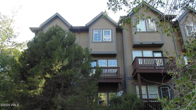 rear view of property with a balcony