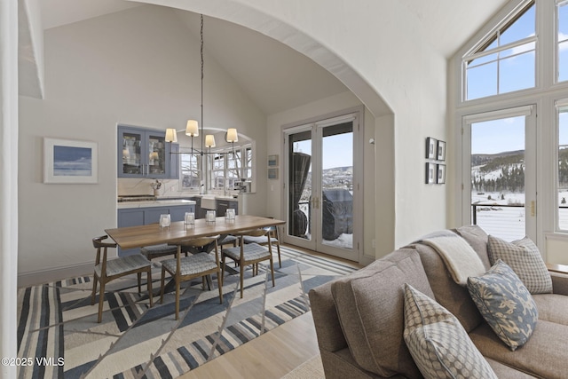 50 Bermuda Dr, Edwards, CO 81632 - dining space with high vaulted ceiling, arched walkways, an inviting chandelier, and a healthy amount of sunlight