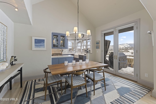 50 Bermuda Dr, Edwards, CO 81632 - dining space with high vaulted ceiling, a mountain view, french doors, light wood finished floors, and baseboards