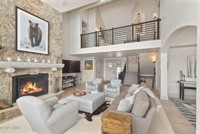 50 Bermuda Dr, Edwards, CO 81632 - living room with baseboards, a fireplace, stairs, arched walkways, and wood finished floors
