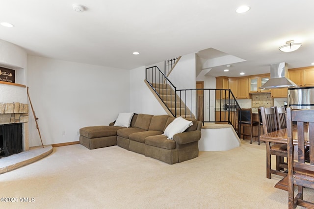 4192 Spruce Way Unit 209-A, Vail, CO 81657 - living room with light carpet, recessed lighting, stairs, a stone fireplace, and baseboards