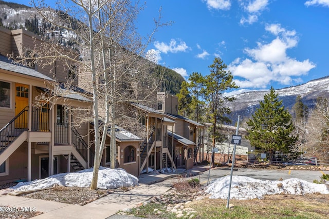 4192 Spruce Way Unit 209-A, Vail, CO 81657 - snow covered property featuring stairs and a mountain view