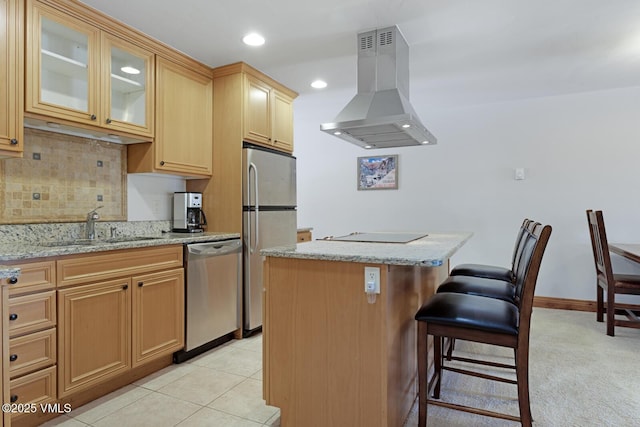 4192 Spruce Way Unit 209-A, Vail, CO 81657 - kitchen with island exhaust hood, appliances with stainless steel finishes, a kitchen island, tasteful backsplash, and a breakfast bar