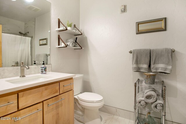 bathroom featuring vanity, toilet, and a shower with shower curtain