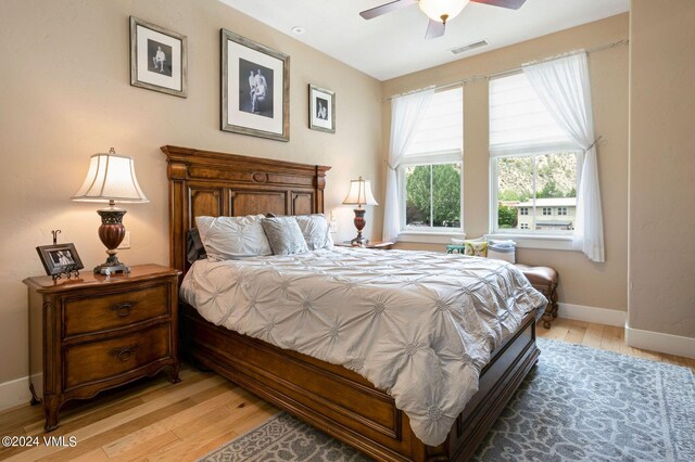 bedroom with ceiling fan and light hardwood / wood-style floors