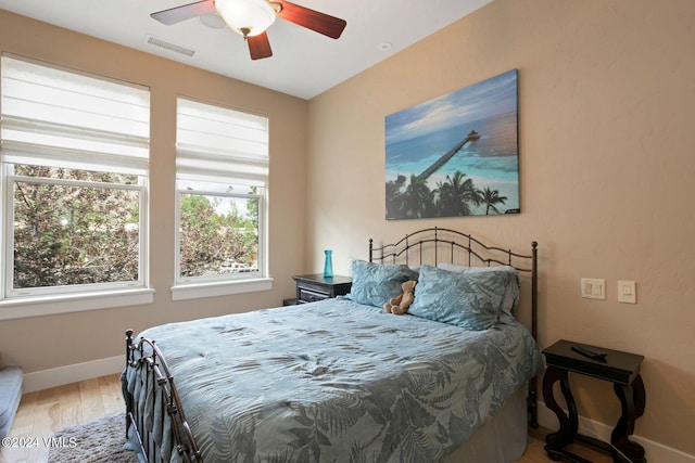 bedroom with hardwood / wood-style flooring and ceiling fan