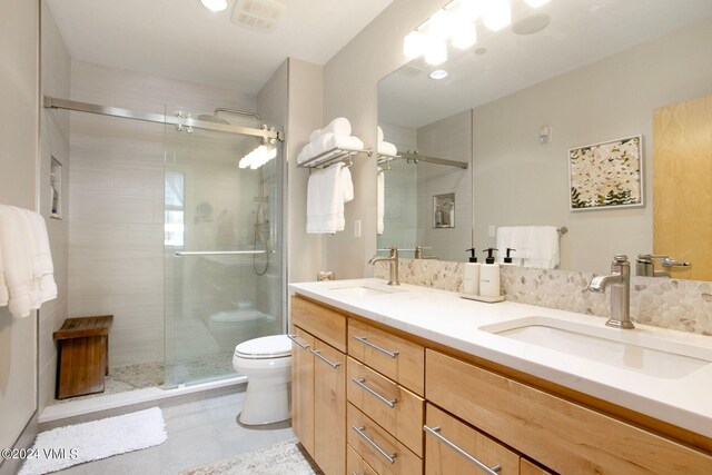 bathroom featuring vanity, walk in shower, and toilet