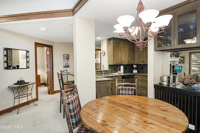 kitchen with dishwasher, backsplash, light colored carpet, dark brown cabinets, and an inviting chandelier