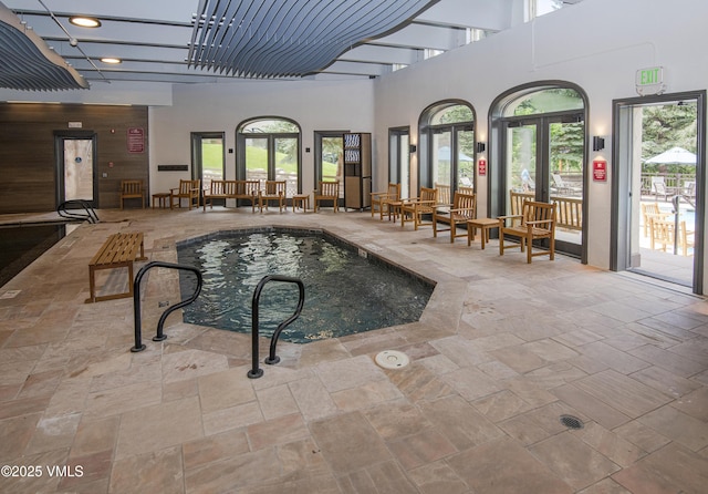 view of swimming pool featuring french doors