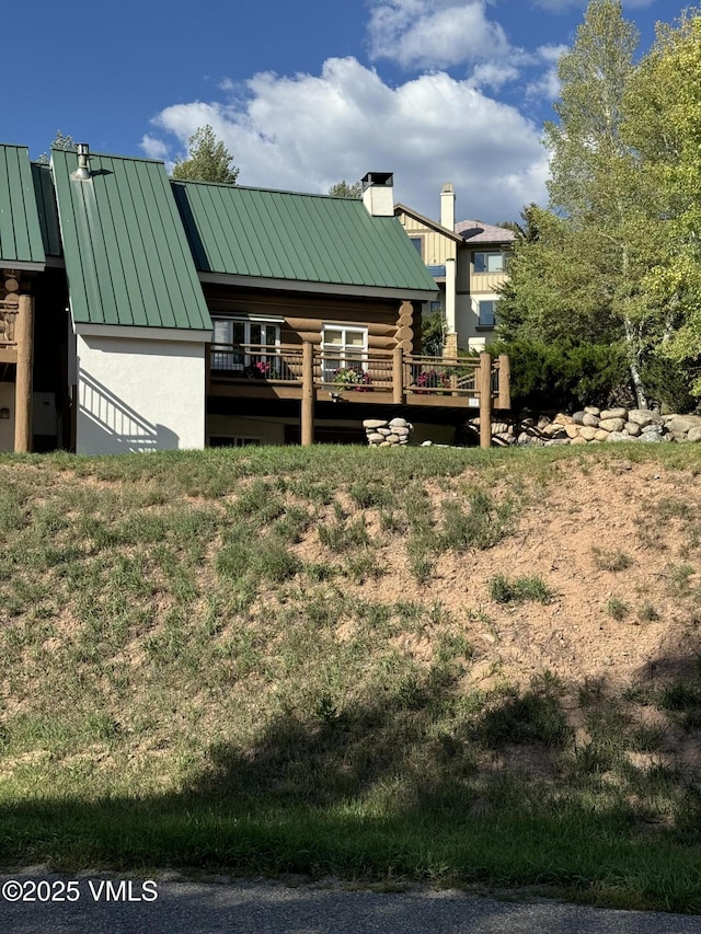 121 Hackamore Rd Unit B, Edwards, CO 81632 - rear view of house featuring a standing seam roof, metal roof, a chimney, a deck, and log exterior