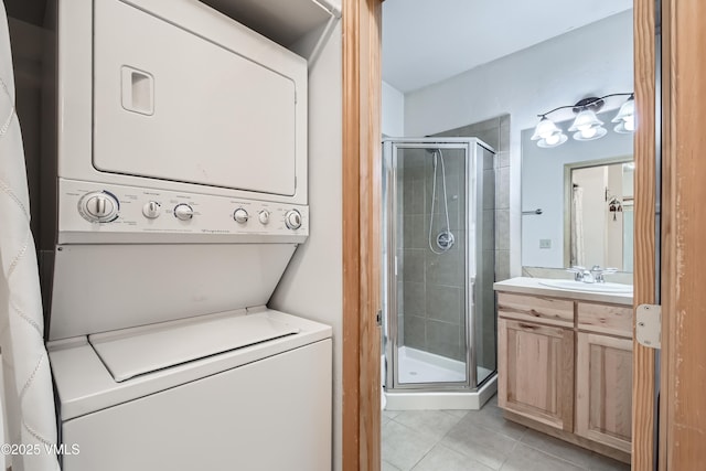 121 Hackamore Rd Unit B, Edwards, CO 81632 - laundry room with stacked washer and clothes dryer, light tile patterned floors, and a sink