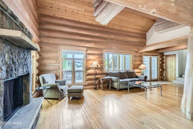 121 Hackamore Rd Unit B, Edwards, CO 81632 - living area featuring a fireplace, wood-type flooring, rustic walls, wood ceiling with exposed beams, and high vaulted ceiling