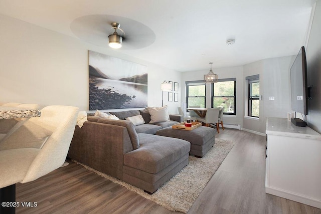 216 Main St Unit R316, Edwards, CO 81632 - living room featuring wood finished floors, baseboard heating, and a ceiling fan