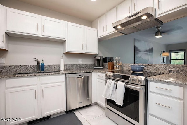 216 Main St Unit R316, Edwards, CO 81632 - kitchen with appliances with stainless steel finishes, under cabinet range hood, white cabinets, light marble finish floors, and light stone countertops