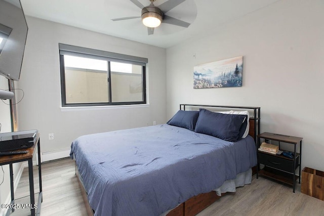 216 Main St Unit R316, Edwards, CO 81632 - bedroom featuring wood finished floors, a baseboard heating unit, and ceiling fan
