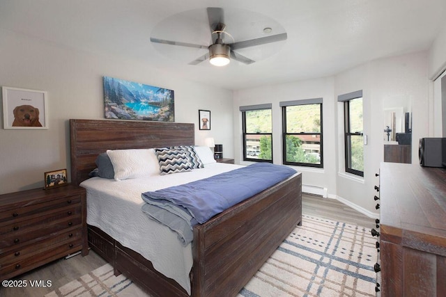 216 Main St Unit R316, Edwards, CO 81632 - bedroom featuring a baseboard radiator, light wood finished floors, and ceiling fan
