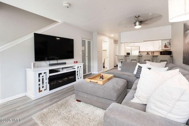 216 Main St Unit R316, Edwards, CO 81632 - living room with light wood-style flooring and a ceiling fan