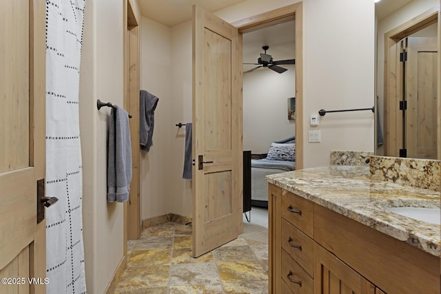 12 Cabin Creek Ln, Edwards, CO 81632 - bathroom featuring vanity, ensuite bath, stone finish flooring, and ceiling fan