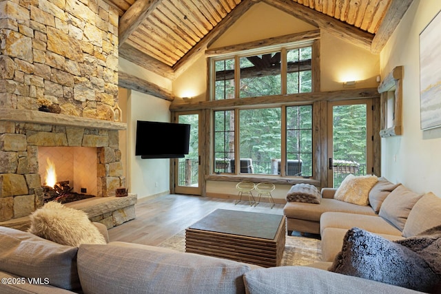 12 Cabin Creek Ln, Edwards, CO 81632 - living area with a wooden ceiling with exposed beams, wood finished floors, high vaulted ceiling, and a fireplace