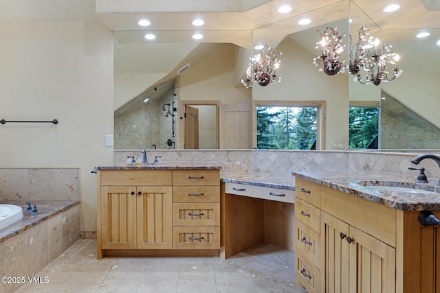 12 Cabin Creek Ln, Edwards, CO 81632 - full bathroom featuring a chandelier, two vanities, a stall shower, a garden tub, and vaulted ceiling