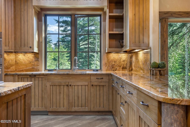 12 Cabin Creek Ln, Edwards, CO 81632 - kitchen featuring light stone counters, backsplash, and light wood-style flooring
