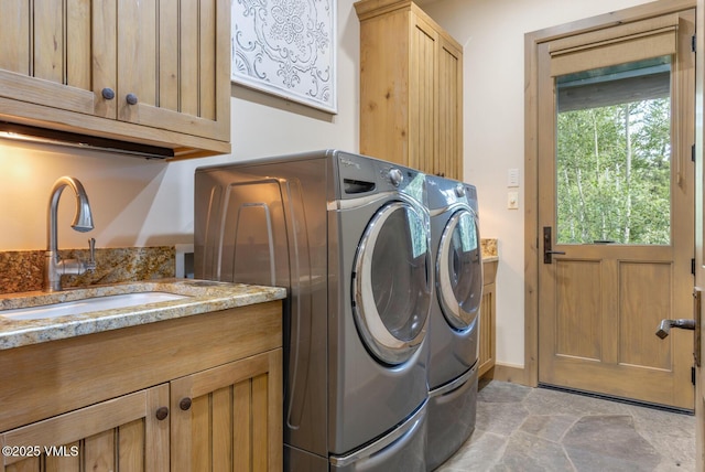 12 Cabin Creek Ln, Edwards, CO 81632 - laundry room featuring washing machine and clothes dryer, cabinet space, and light stone finish flooring