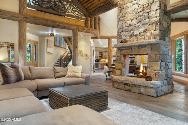 12 Cabin Creek Ln, Edwards, CO 81632 - living area with high vaulted ceiling, wood finished floors, stairway, plenty of natural light, and a fireplace