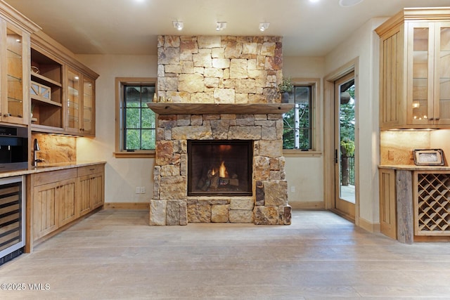 12 Cabin Creek Ln, Edwards, CO 81632 - unfurnished living room with beverage cooler, a fireplace, and light wood-type flooring
