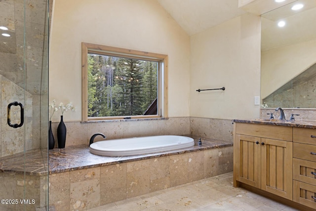 12 Cabin Creek Ln, Edwards, CO 81632 - bathroom with vanity, a bath, vaulted ceiling, a shower stall, and recessed lighting