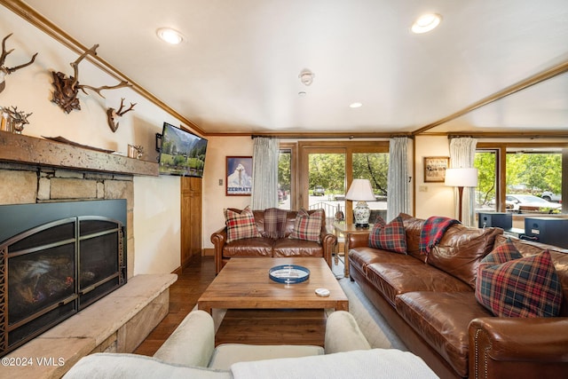 living room featuring crown molding, a fireplace, and dark hardwood / wood-style floors