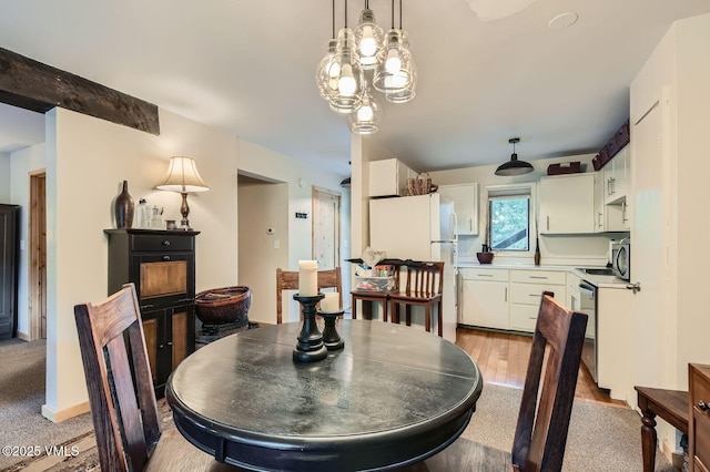 1880 Meadow Ridge Rd Unit 7, Vail, CO 81657 - dining room featuring light carpet and a chandelier