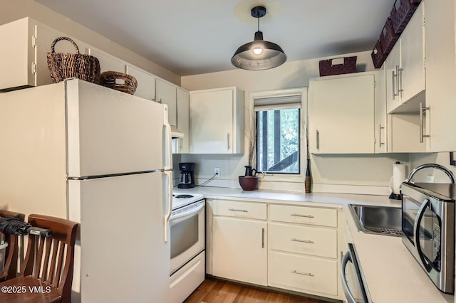 1880 Meadow Ridge Rd Unit 7, Vail, CO 81657 - kitchen with white appliances, light countertops, light wood finished floors, and white cabinets
