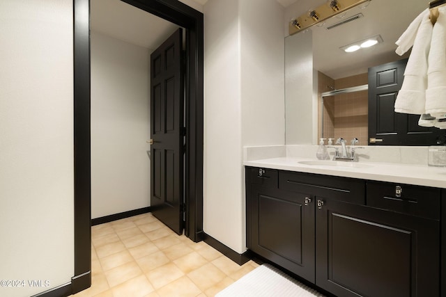 bathroom with vanity and tiled shower