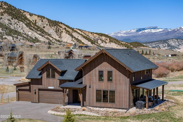 687 Hunters View Ln, Eagle, CO 81631 - view of front of home with roof with shingles, a mountain view, driveway, and an attached garage
