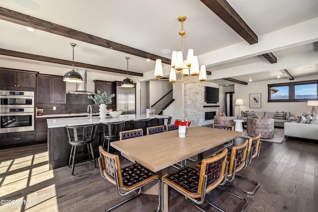 687 Hunters View Ln, Eagle, CO 81631 - dining space with dark wood-style floors, a chandelier, and beamed ceiling