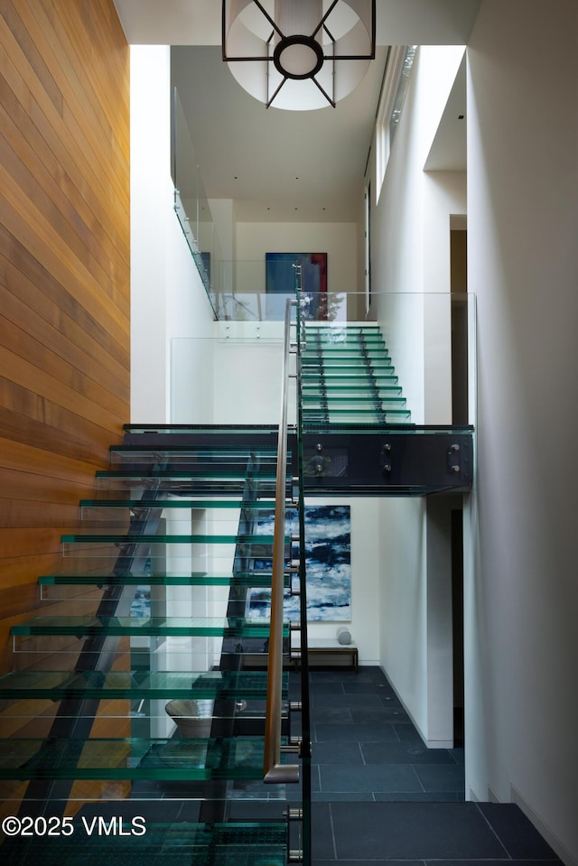 344 Beaver Dam Rd, Vail, CO 81657 - stairs featuring wooden walls and tile patterned floors